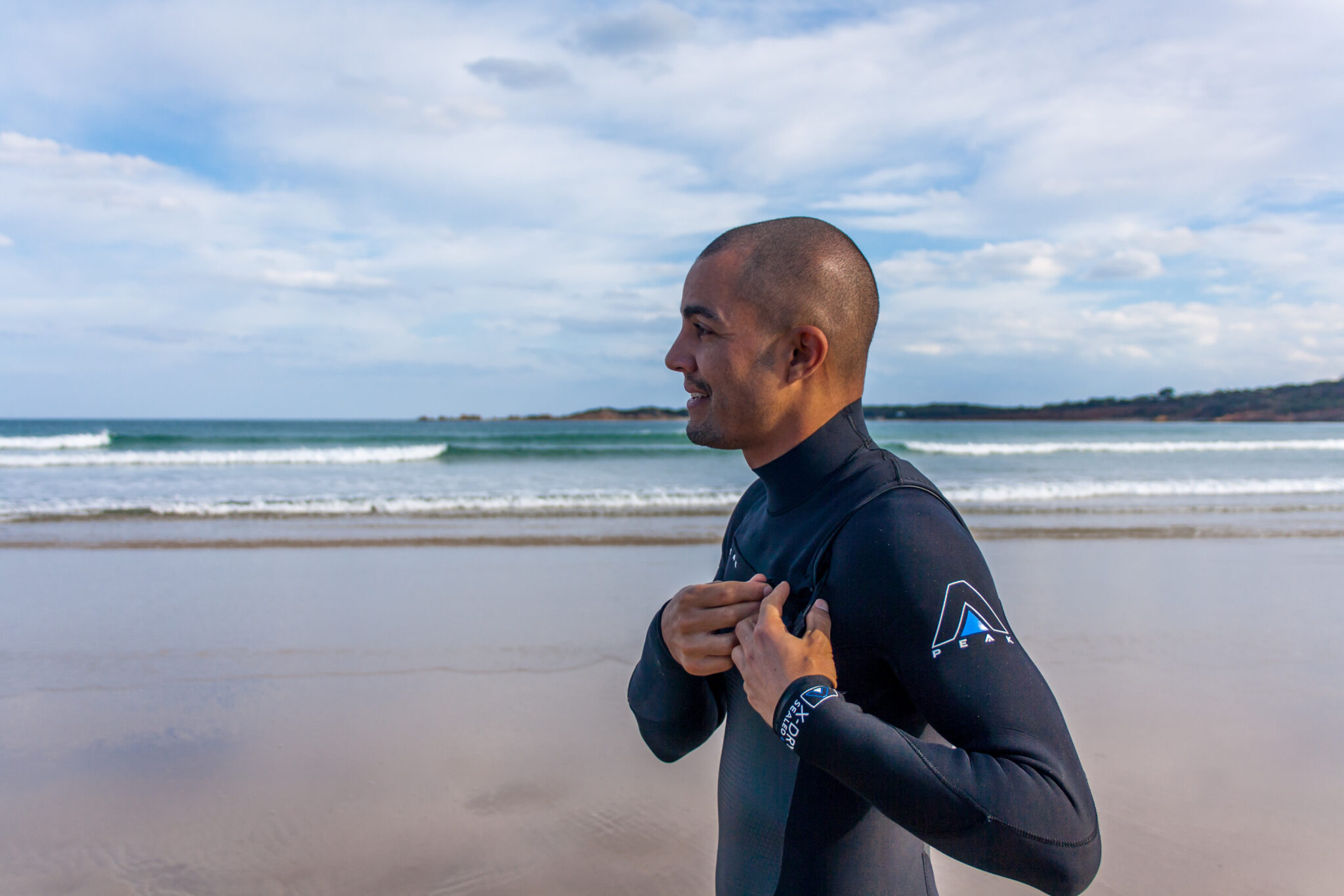 Man with wetsuit on for an ocean swim
