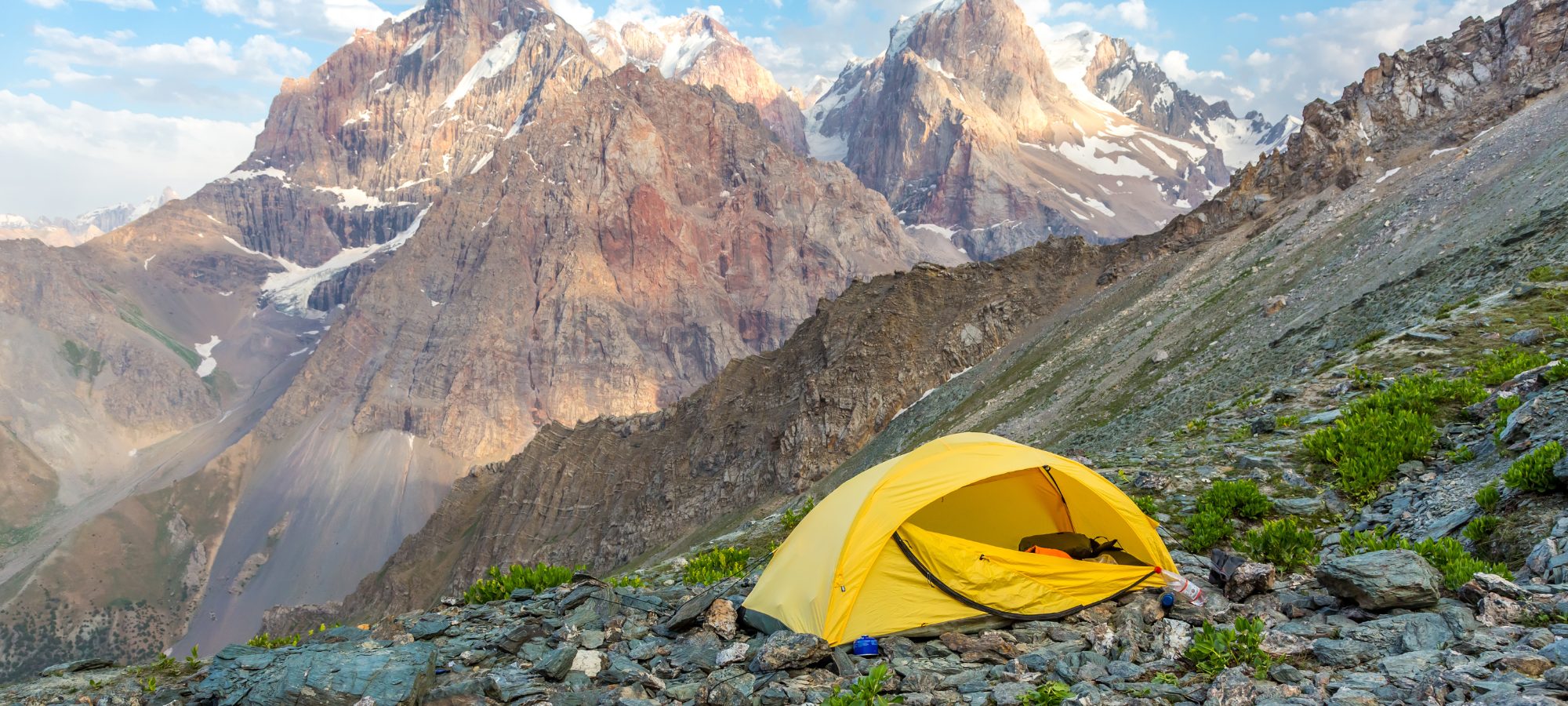 buying a tent, yellow tent on a mountainside